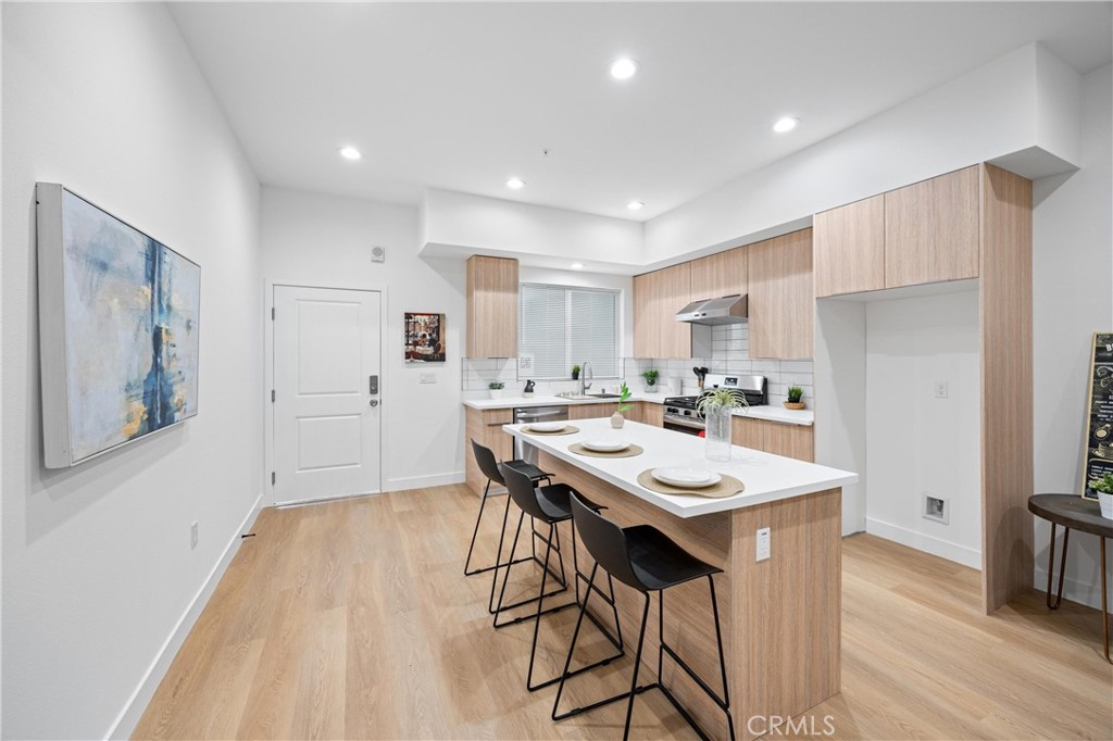 13857 Leffingwell Road Whittier, CA 90604 - Photo 24 of 32 a kitchen with a sink a table and chairs in it