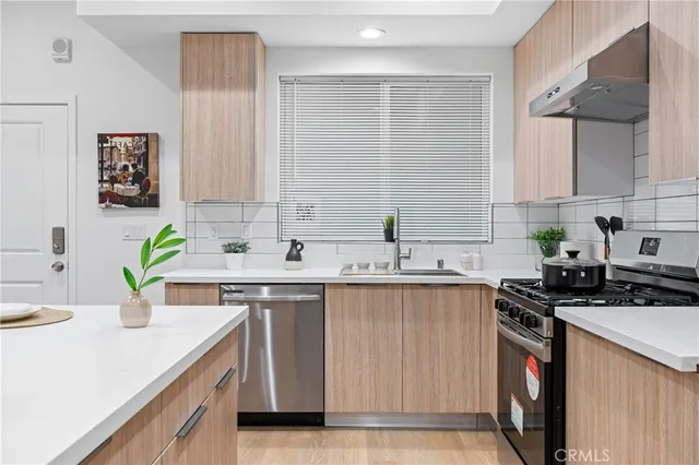 a kitchen with a sink stove and cabinets