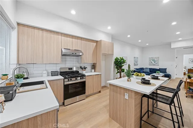 a kitchen with a sink stove and white cabinets