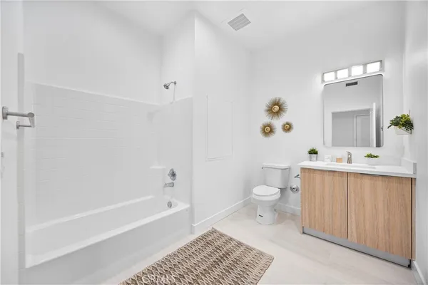 a bathroom with a toilet a sink and bathtub