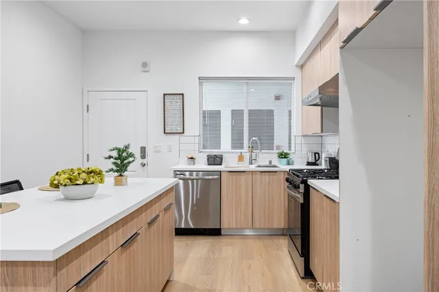 a kitchen with a sink stove and cabinets