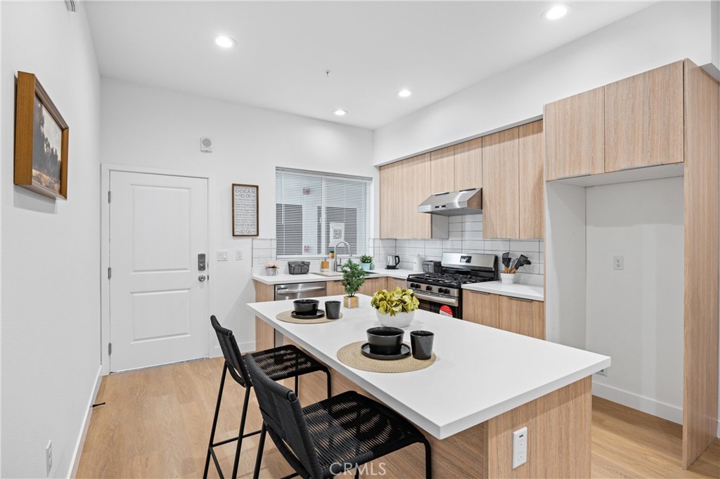 13857 Leffingwell Road Whittier, CA 90604 - Photo 5 of 32 a view of a dining room with furniture and wooden floor