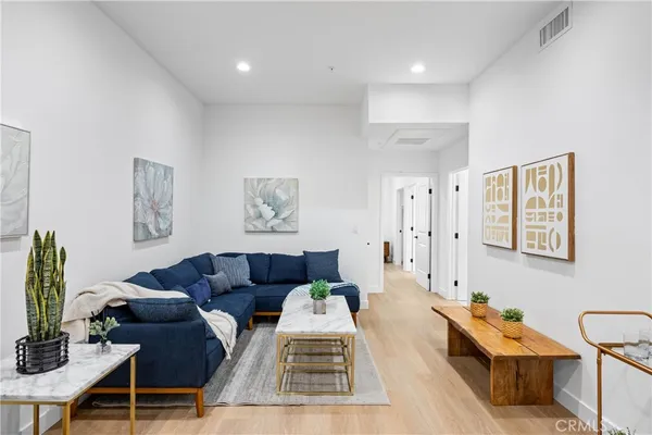 a living room with furniture and wooden floor