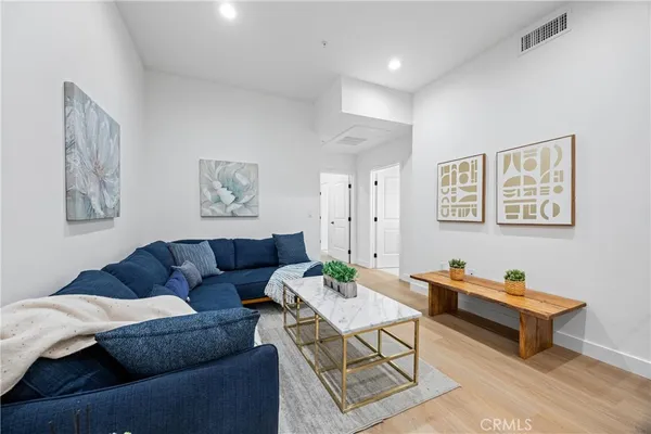a living room with furniture and a painting on the wall