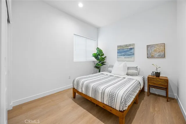 a bedroom with a bed and a potted plant