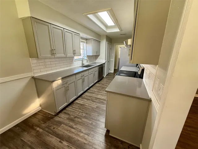 a kitchen with sink and cabinets