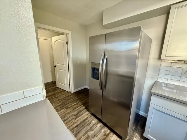 a view of a refrigerator in kitchen