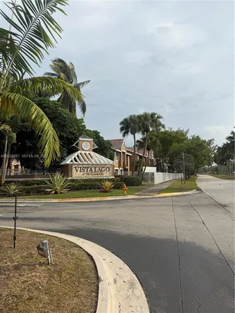 a view of a tennis court with a palm trees