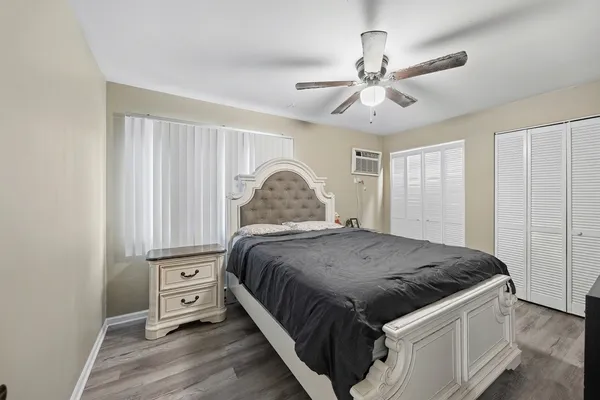 a spacious bedroom with a bed and a chandelier