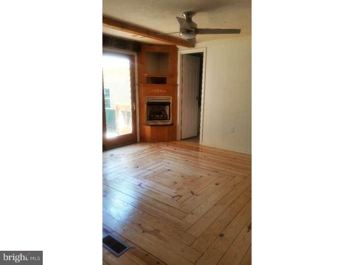 228 Cambridge Road Coatesville, PA 19320 - Photo 8 of 21 Master suite with hardwood flooring & fireplace.