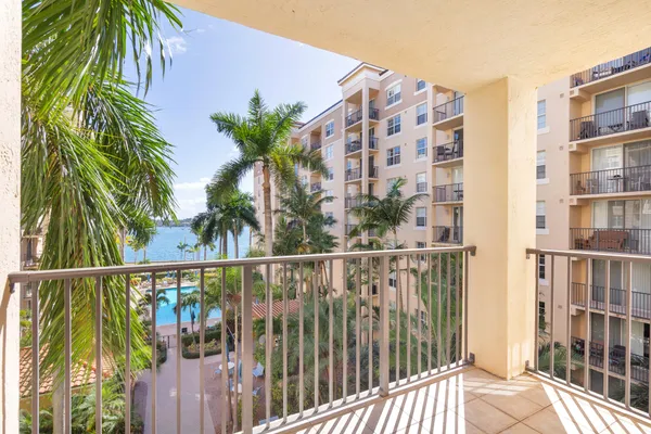 a view of a palm trees from a balcony