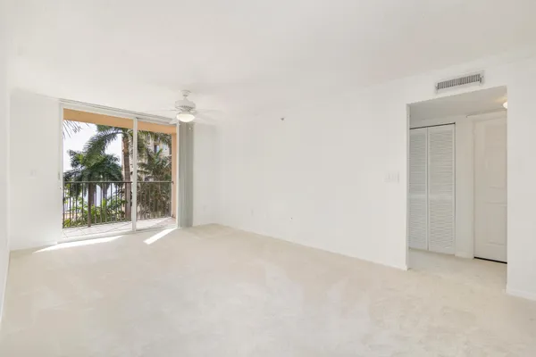 an empty room with windows and pool table