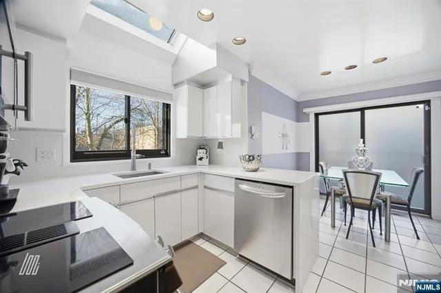a kitchen with a sink and chairs