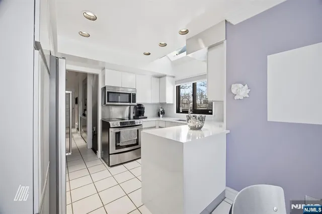 a kitchen with a sink stainless steel appliances and cabinets