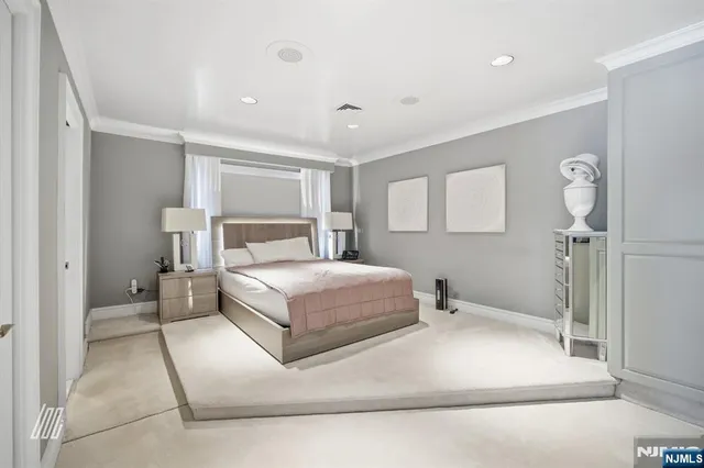 a spacious bedroom with a bed and a lamp