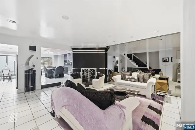 a living room with furniture a flat screen tv and a table