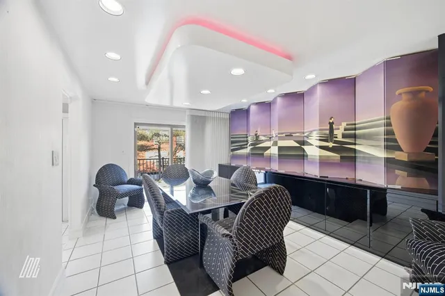 a kitchen with granite countertop a sink a stove a dining table and chairs