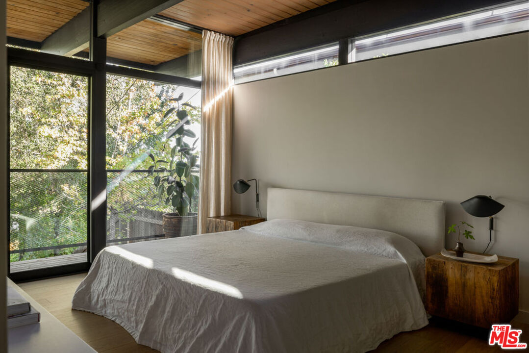 300 Anita Drive Pasadena, CA 91105 - Photo 17 of 26 a bedroom with a bed and wooden floor