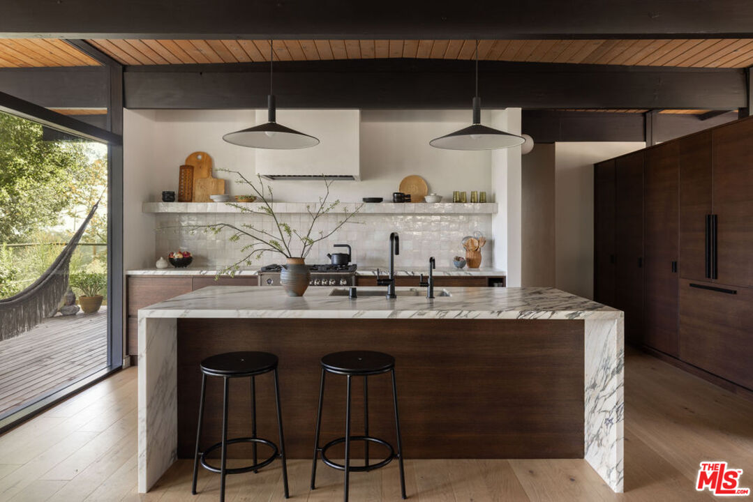 300 Anita Drive Pasadena, CA 91105 - Photo 7 of 26 a kitchen with granite countertop a table and chairs in it