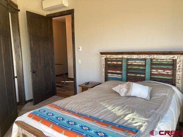 8935 County Road 5 Ridgway, CO 81432 - Photo 19 of 35 a bedroom with a bed and a dresser next to a window