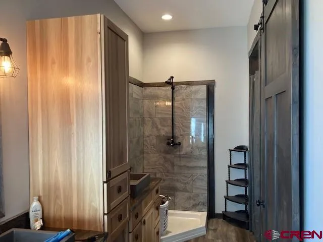 a living room with furniture wooden floor and a floor to ceiling window