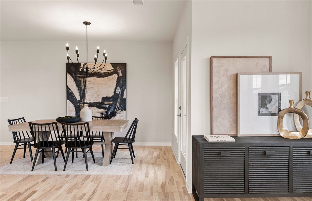 399 Neponset Street, Unit 101 Canton, MA 02021 - Photo 7 of 19 a view of a dining room with furniture and wooden floor