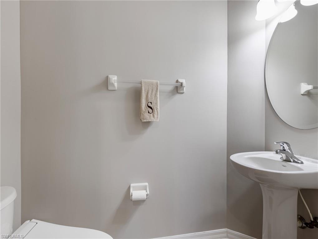 20026 Larino Loop Estero, FL 33928 - Photo 14 of 48 a bathroom with a sink a mirror and a toilet