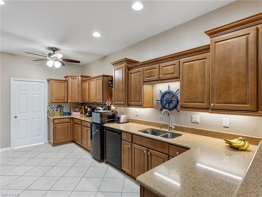 20026 Larino Loop Estero, FL 33928 - Photo 17 of 48 a kitchen with stainless steel appliances granite countertop a sink dishwasher stove and refrigerator