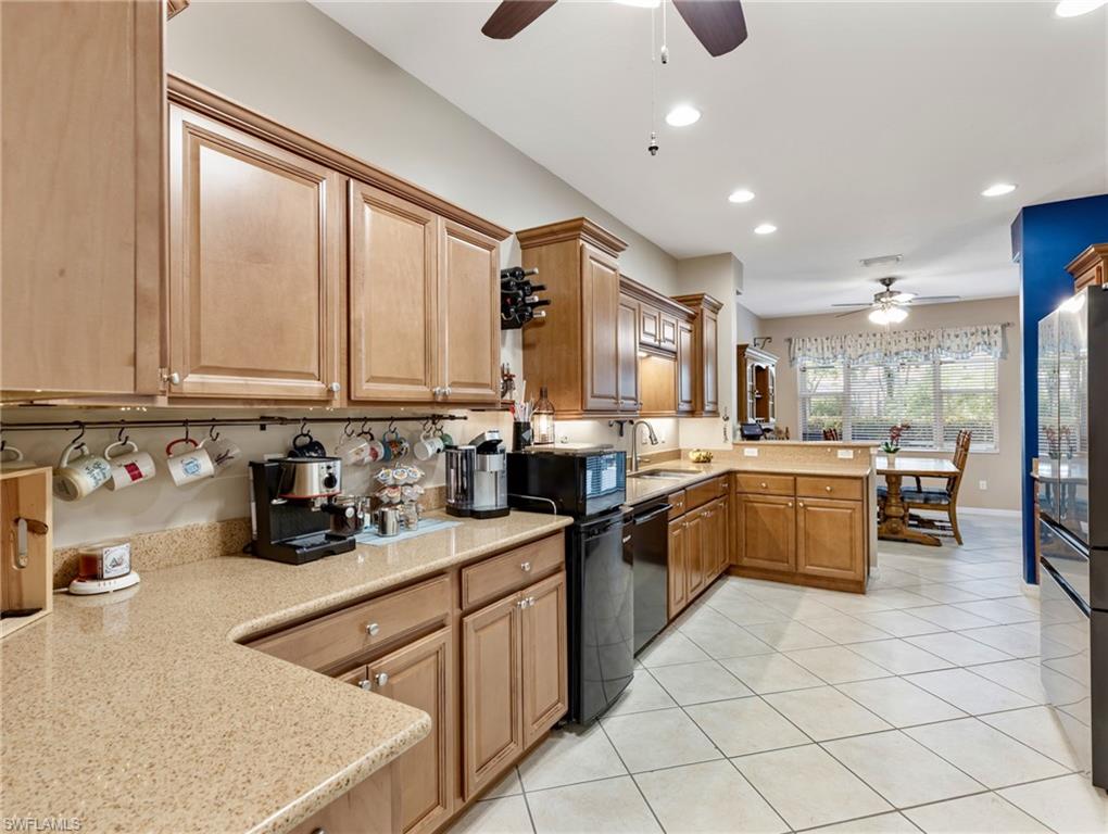 20026 Larino Loop Estero, FL 33928 - Photo 19 of 48 a kitchen with counter top space cabinets and stainless steel appliances