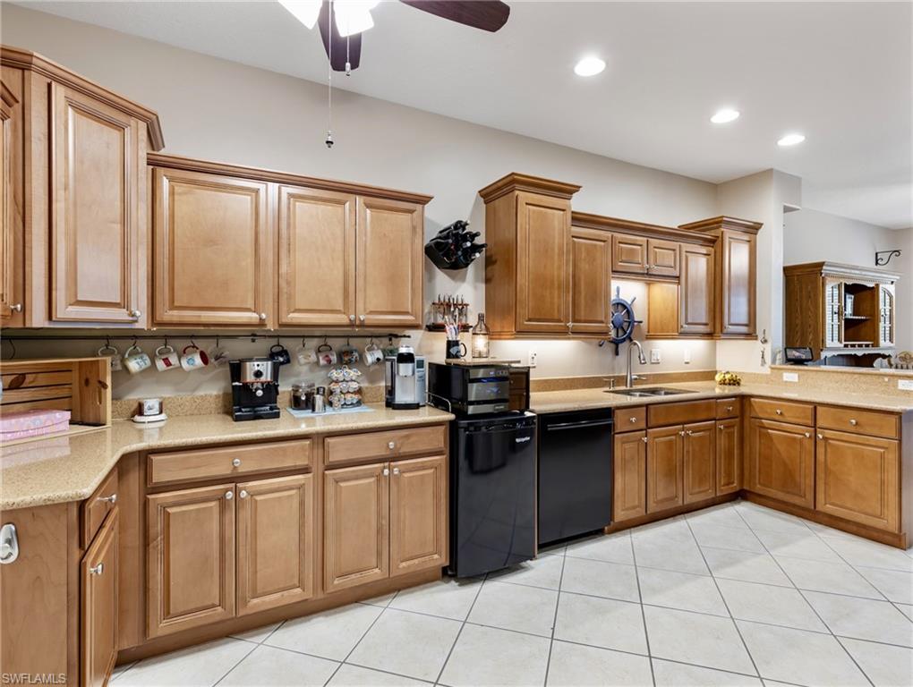 20026 Larino Loop Estero, FL 33928 - Photo 20 of 48 a kitchen with a sink stove and cabinets