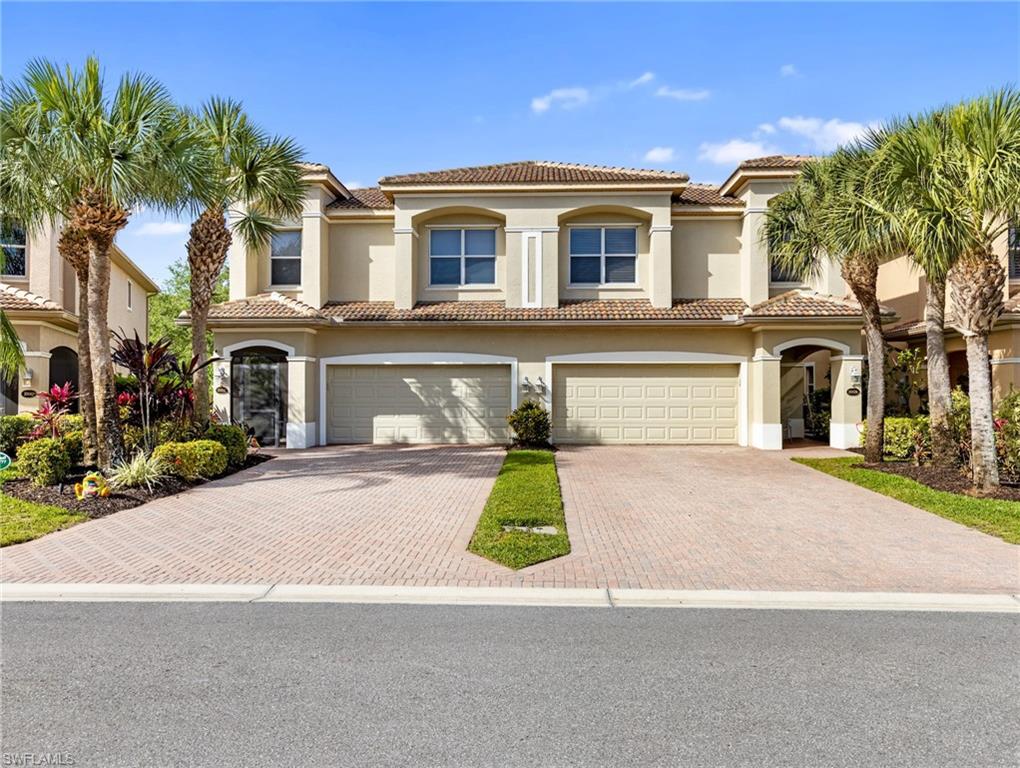 20026 Larino Loop Estero, FL 33928 - Photo 2 of 48 a front view of a house with garden