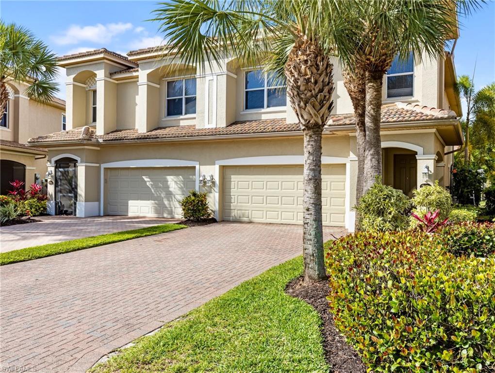 20026 Larino Loop Estero, FL 33928 - Photo 3 of 48 a front view of a house with garden