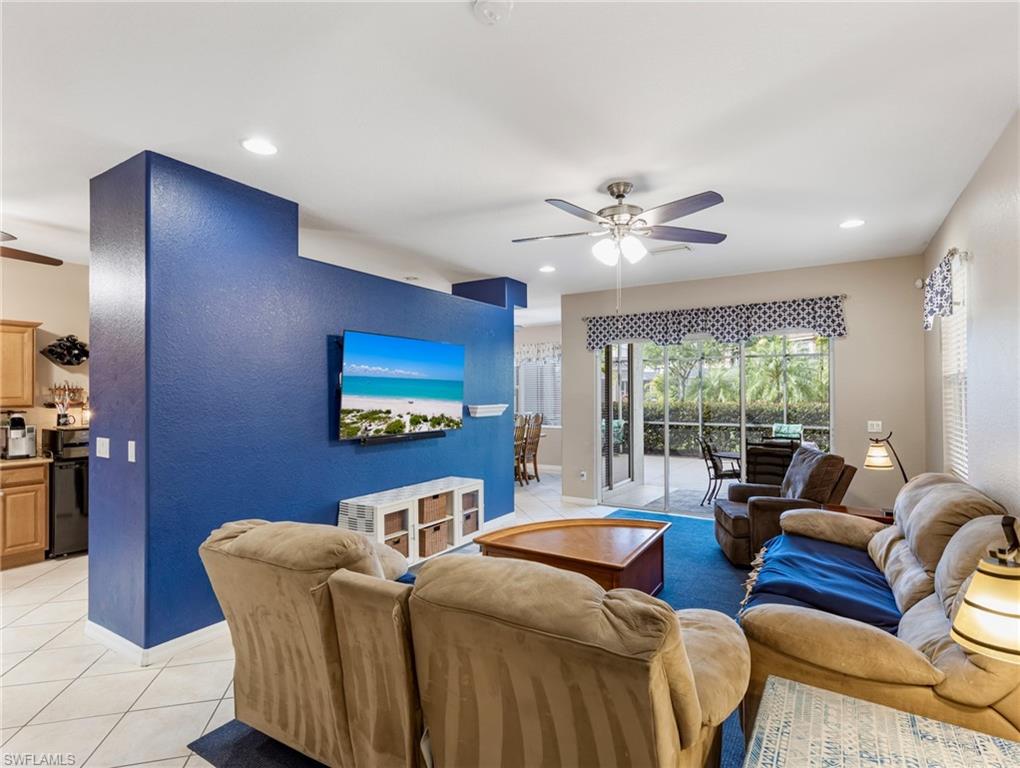 20026 Larino Loop Estero, FL 33928 - Photo 4 of 48 a living room with furniture a large window and a chandelier