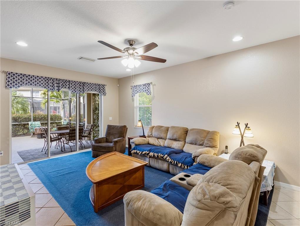 20026 Larino Loop Estero, FL 33928 - Photo 7 of 48 a living room with furniture wooden floor and a large window
