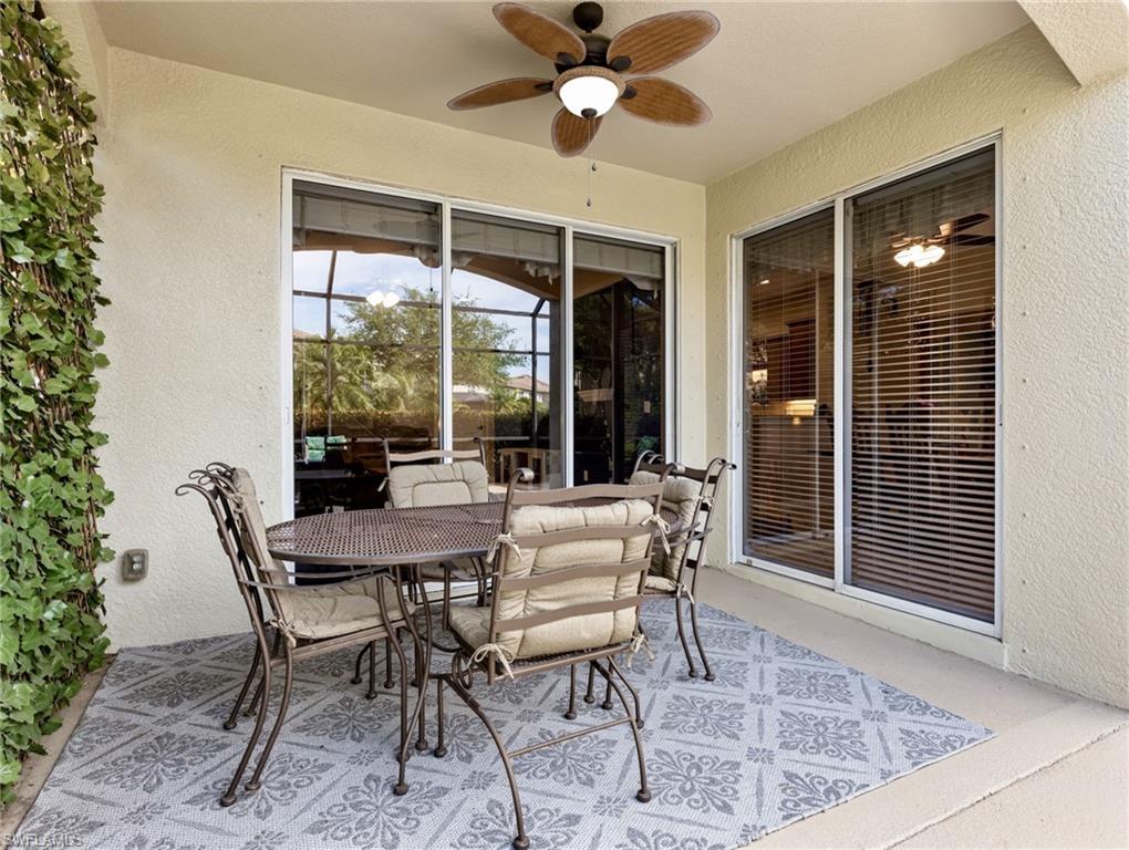 20026 Larino Loop Estero, FL 33928 - Photo 9 of 48 a view of a dining room with furniture wooden floor and chandelier