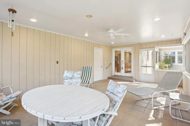 a dining room with furniture a chandelier and window