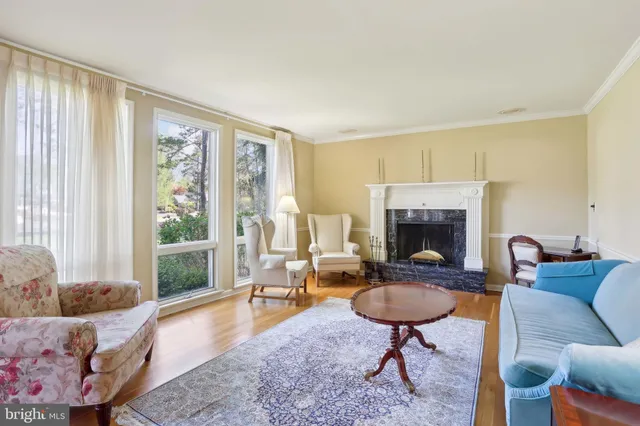 a bathroom with a granite countertop sink a toilet a mirror and window