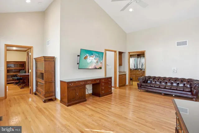 a spacious bedroom with a large bed and a large window