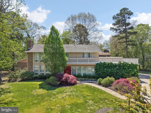 a view of a house with a yard and potted plants