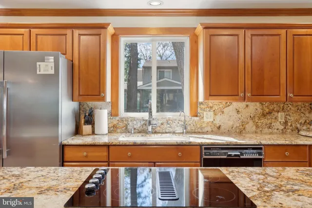 a dining hall with stainless steel appliances a dining table and chairs with the wooden floor