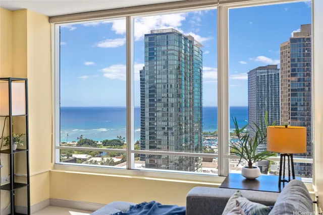 a living room with couch and a floor to ceiling window