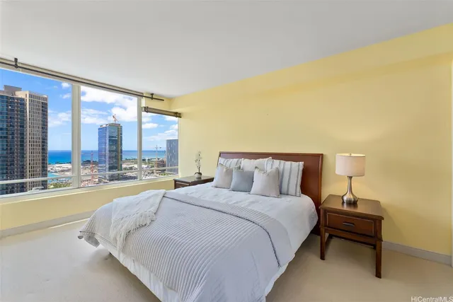 a large bed sitting in a bedroom next to a large window