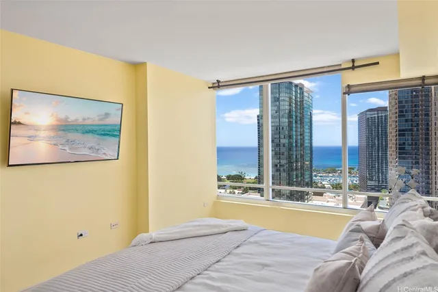 a bed room with a bed and a large window