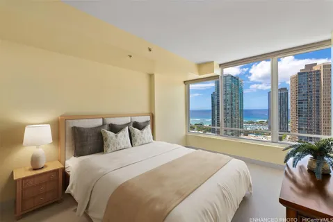 a bedroom with a large bed and a large window