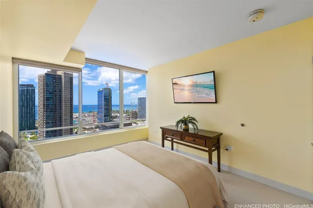 a bedroom with a bed and large windows