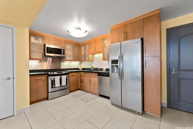 a kitchen with kitchen island a counter top space cabinets and stainless steel appliances
