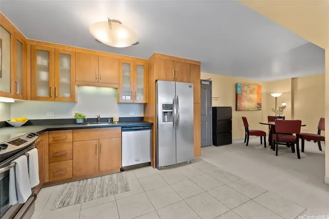 a kitchen with stainless steel appliances granite countertop a refrigerator and a stove top oven