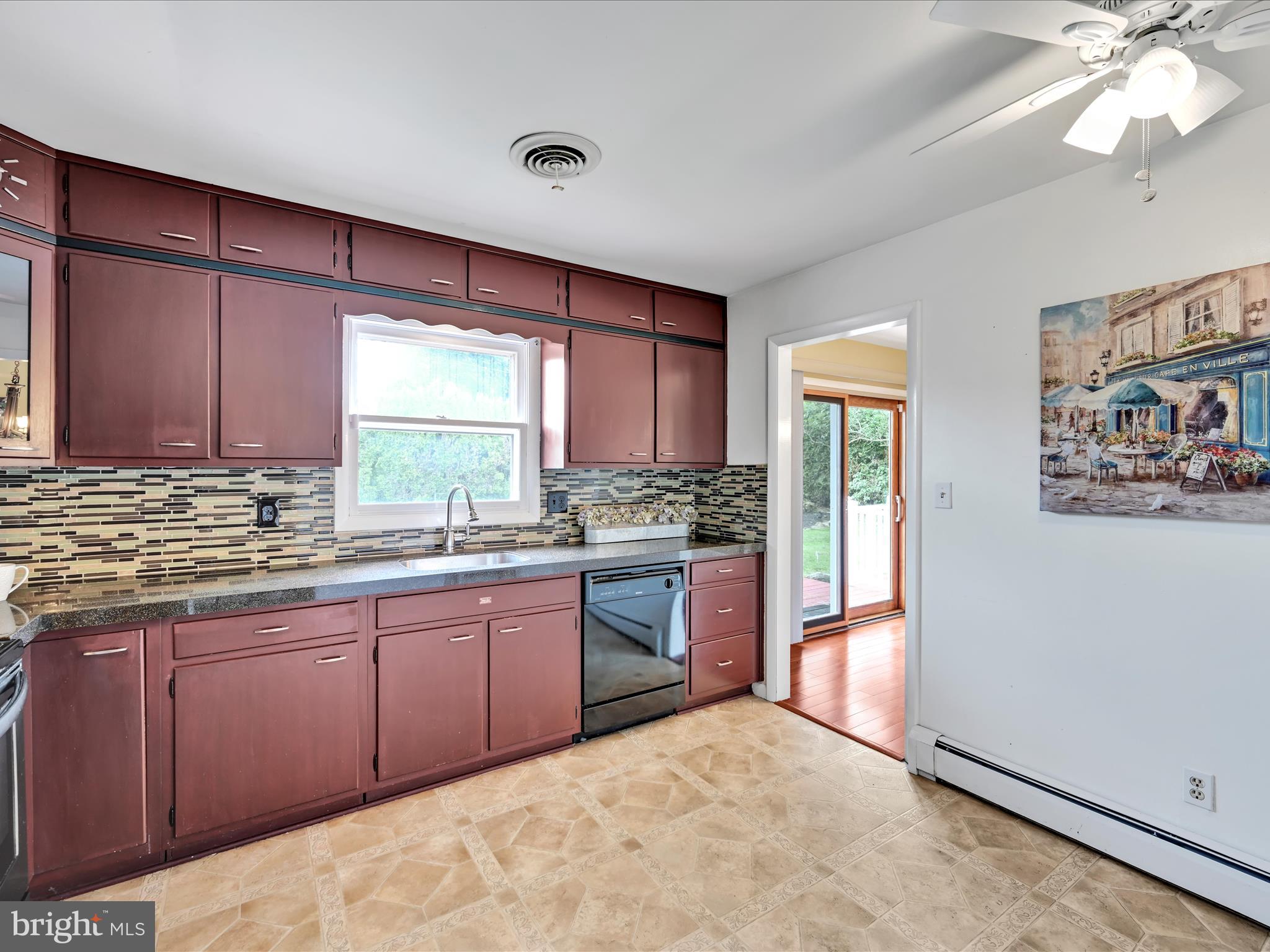 315 Morrison Road Reading, PA 19601 - Photo 11 of 30 a kitchen with stainless steel appliances granite countertop a stove a sink dishwasher and a refrigerator with wooden cabinets