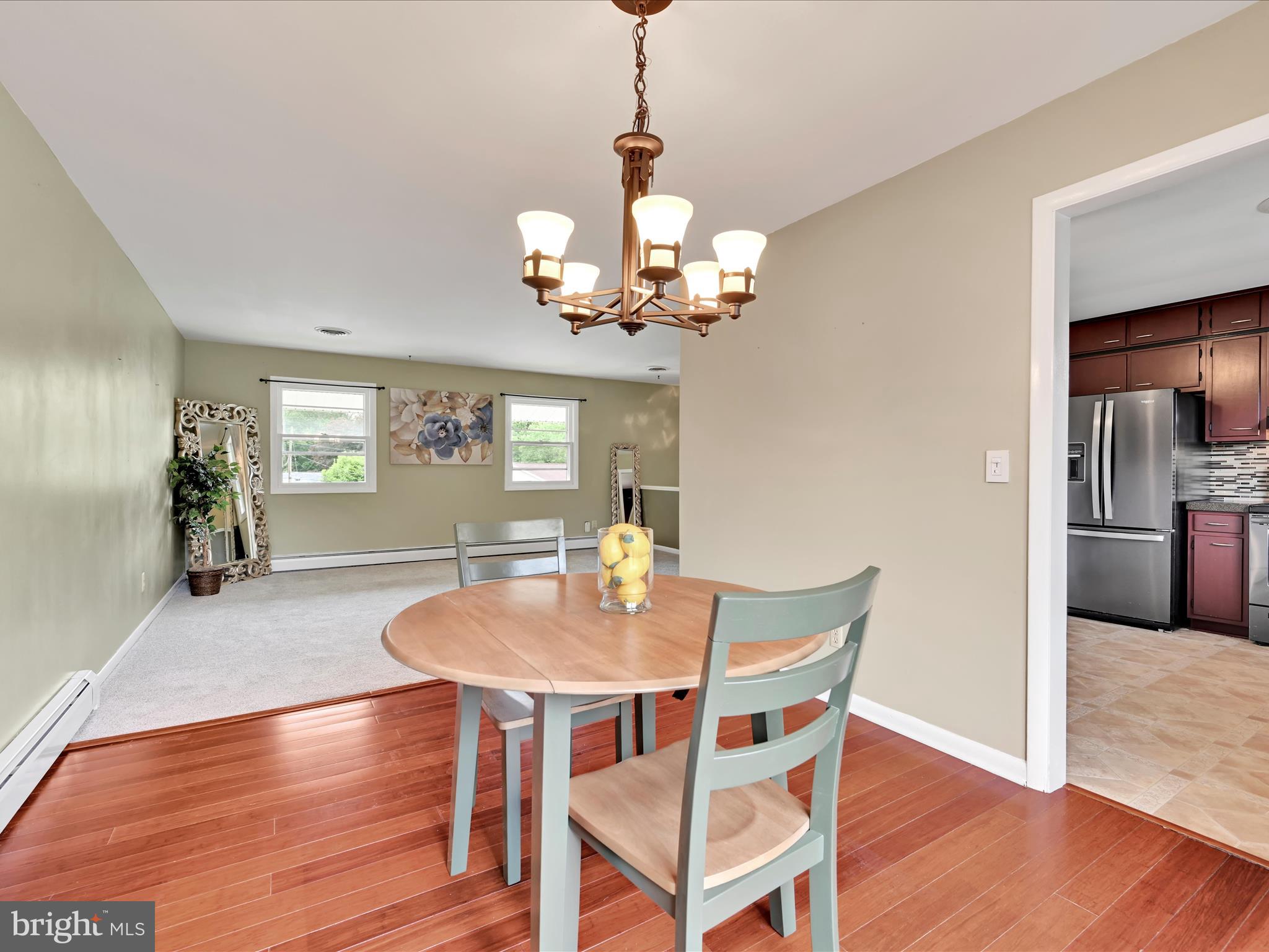 315 Morrison Road Reading, PA 19601 - Photo 8 of 30 a dining room with wooden floor a chandelier a wooden table and chairs