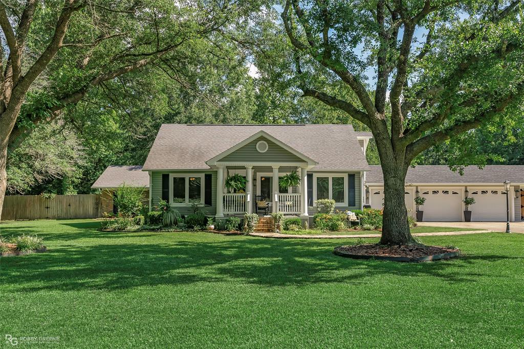 a front view of a house with a yard table and chairs